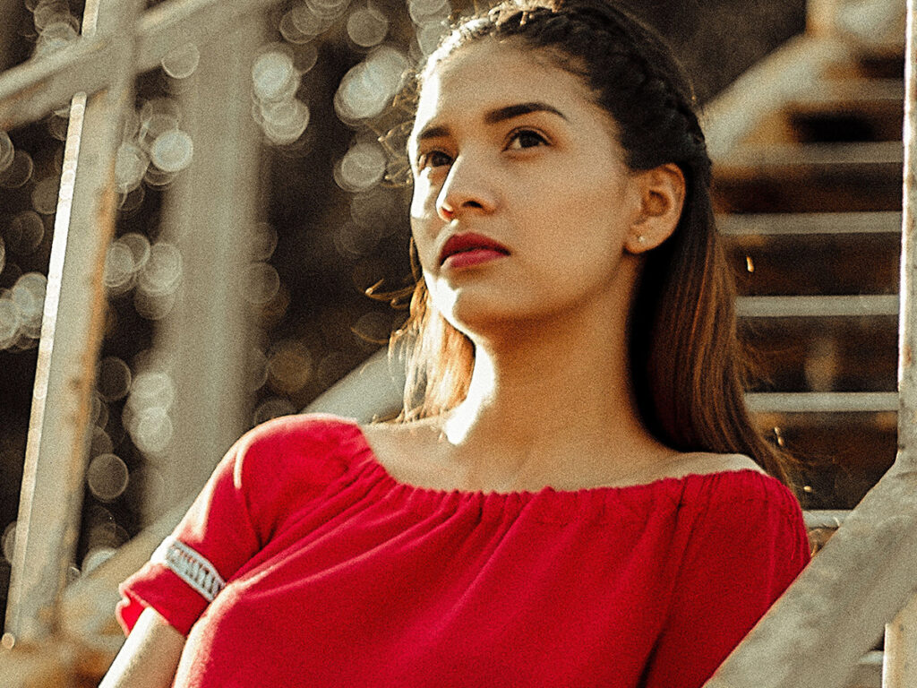 Image of a confident woman in a red dress.