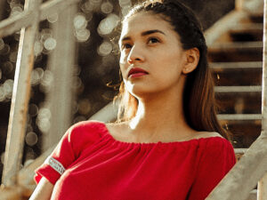 Image of a confident woman in a red dress.