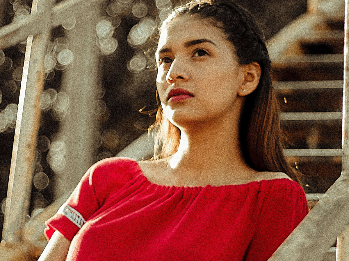 Image of a confident woman in a red dress.