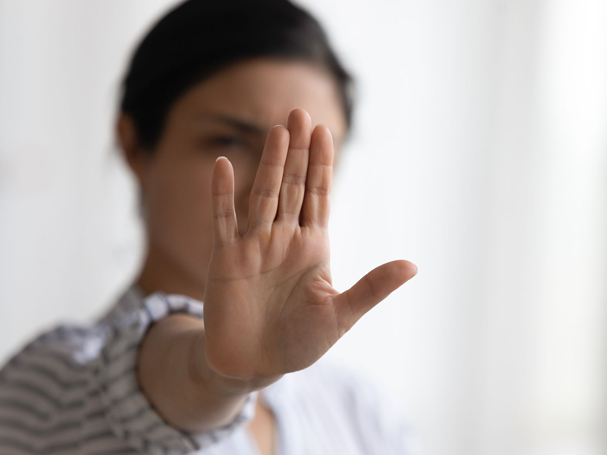 Image of a woman holding up her hand.