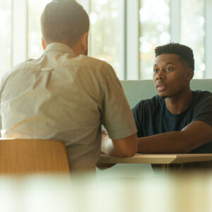 Two men sitting and talking