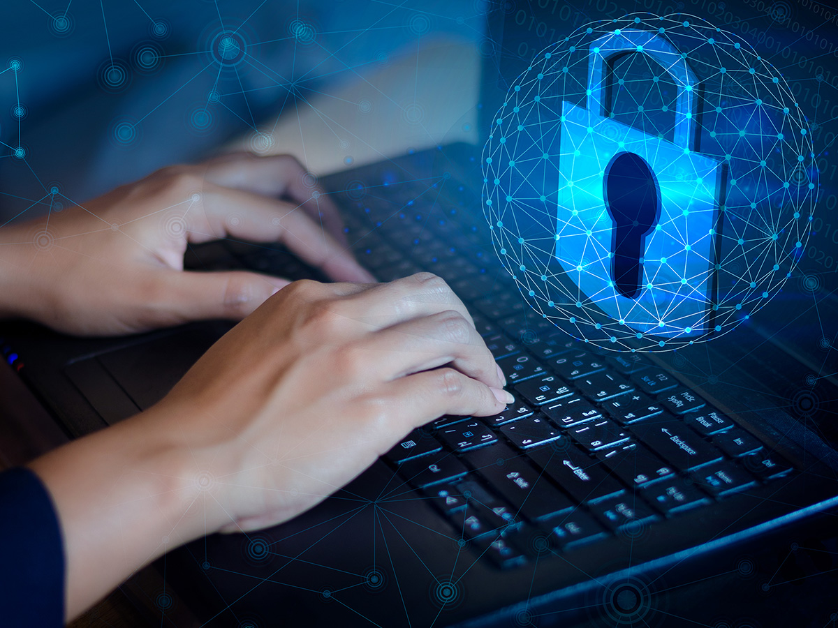 Person working on a laptop with a digital lock on the screen.